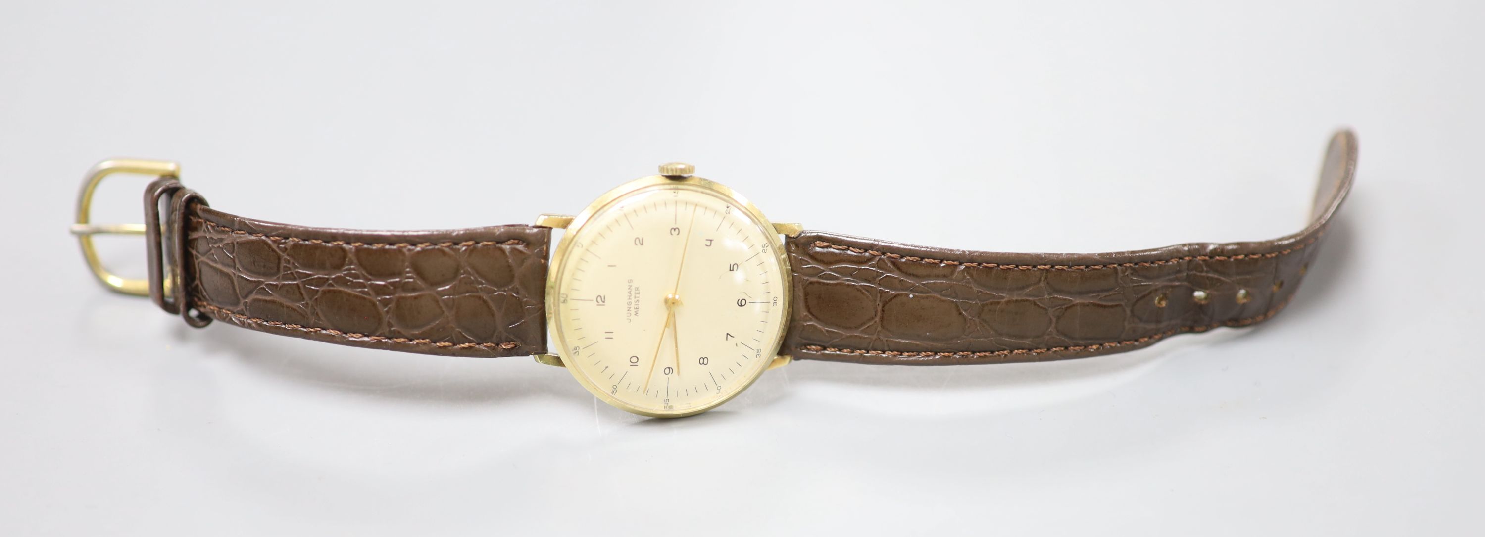 A gentlemans 14ct Junghans Meister manual wind wrist watch, on a associated leather strap and case back inscription,